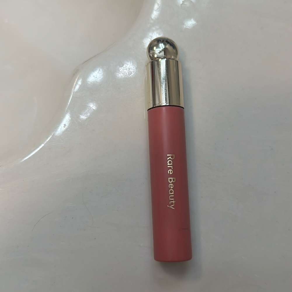 Rare beauty lip oil in shade “Hope”